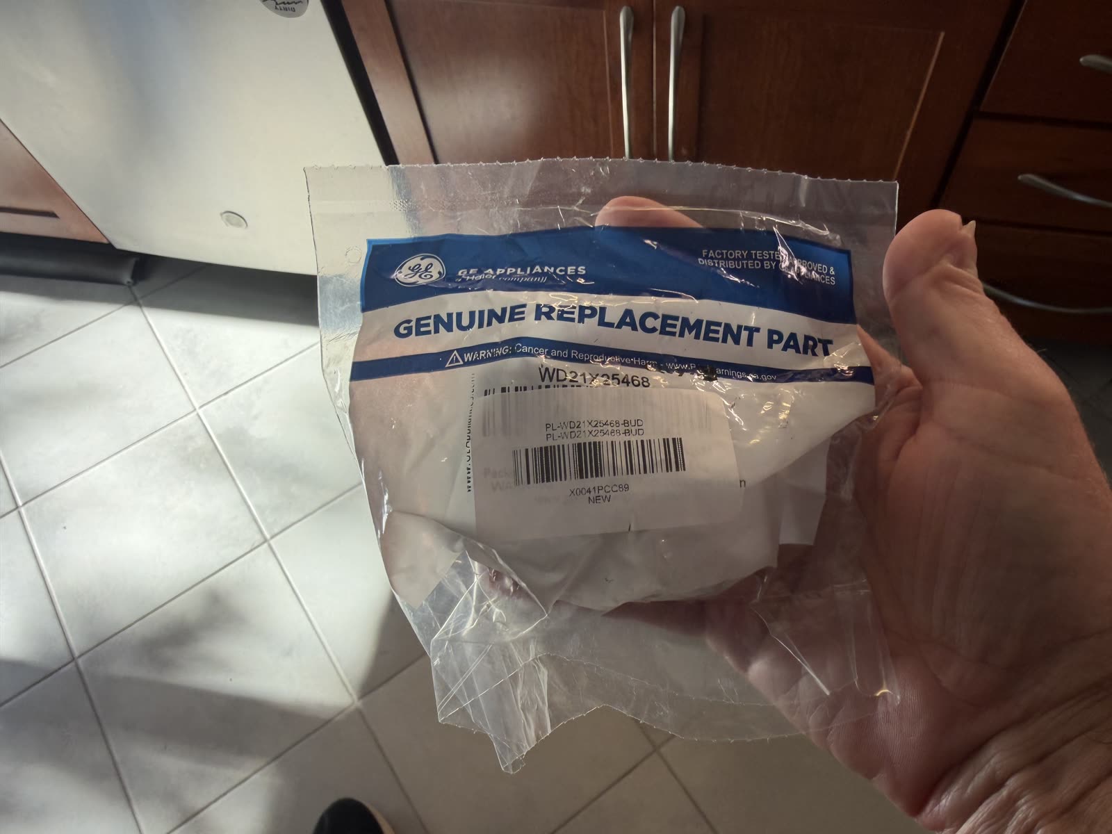 The replacement GE genuine part WD21X25468 in its factory bag