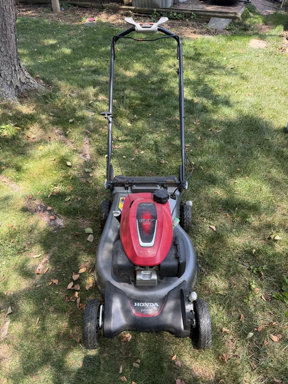 The Honda mower back in the yard after the carburetor swap