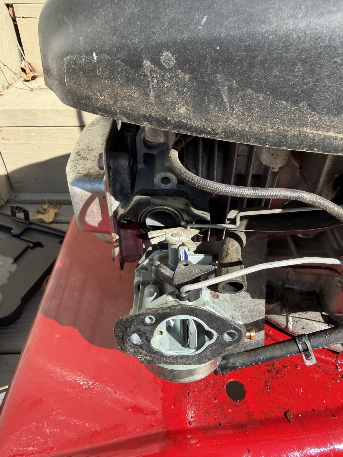 Wider view of the new carburetor with the throttle linkage reconnected